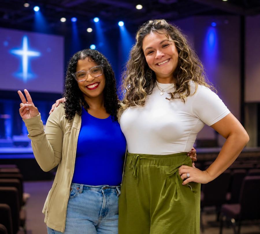 Two smiling greeters at Experience Church