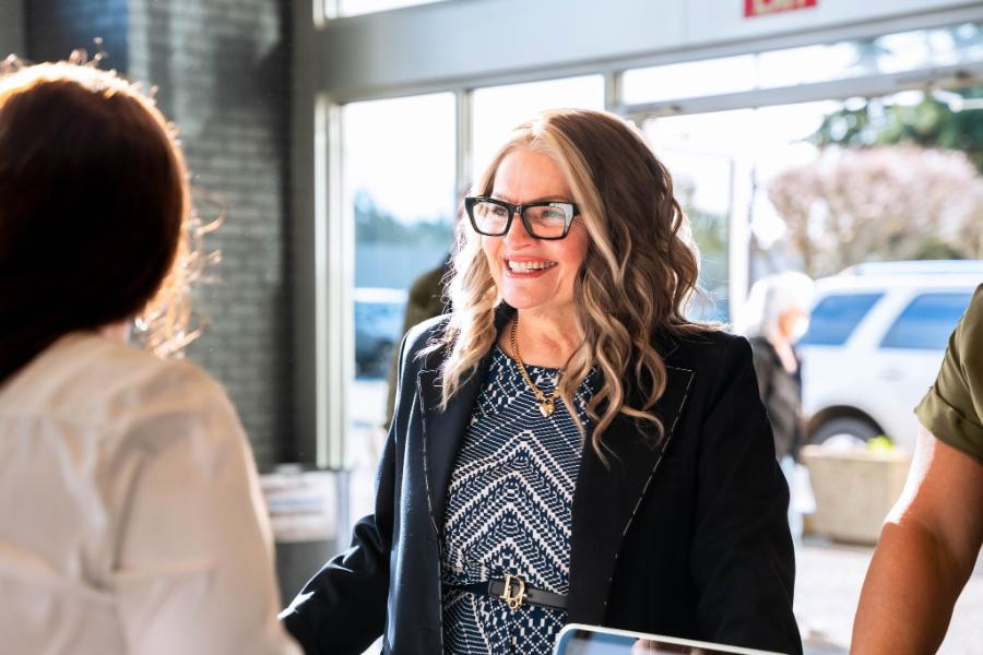 Smiling greeter welcoming guests