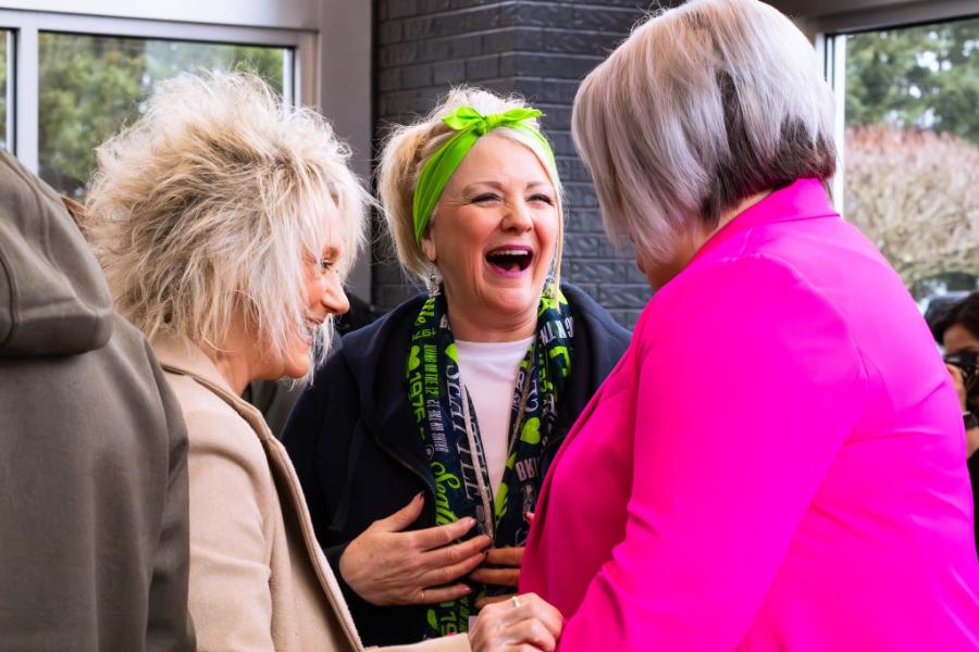 Friends laughing together in the lobby