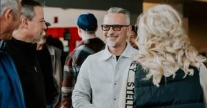 Pastor Dennis greeting guests in Surprise